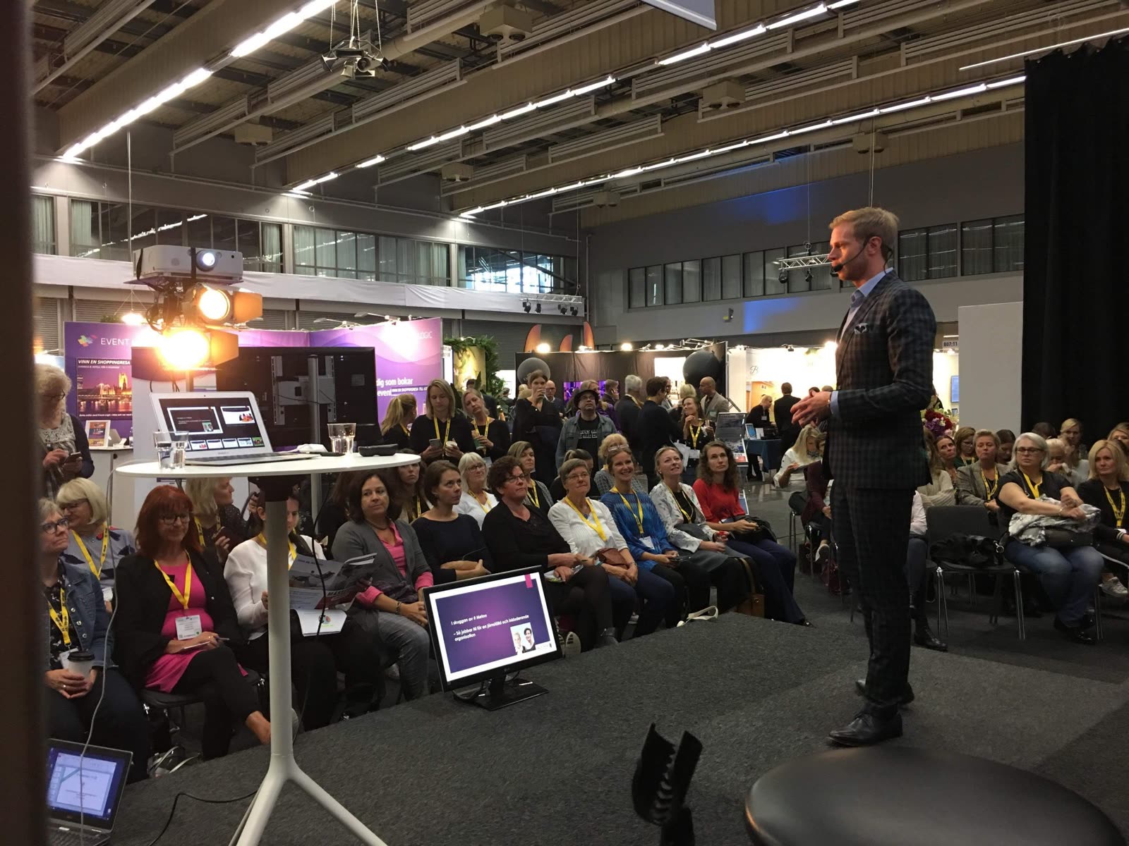 David speaking to a packed audience at a trade fair