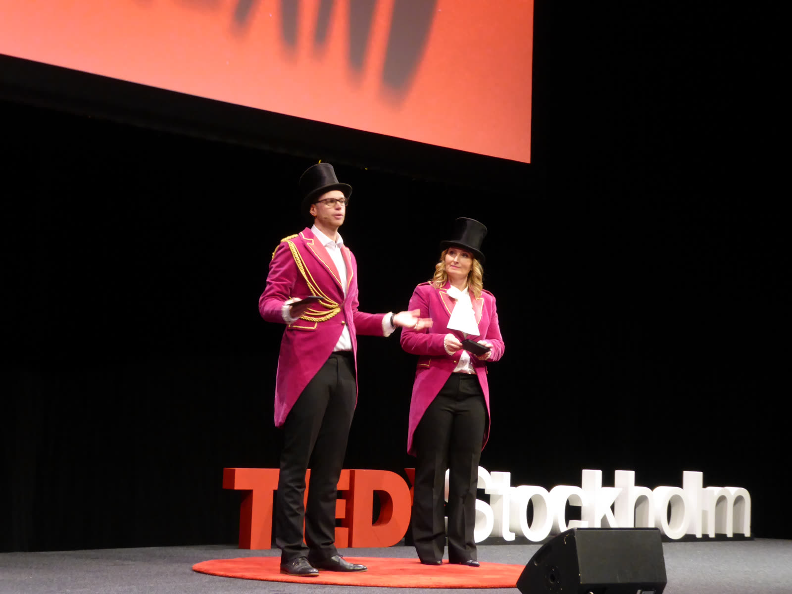 David co-hosting TEDxStockholm in pink tailcoat and top hat